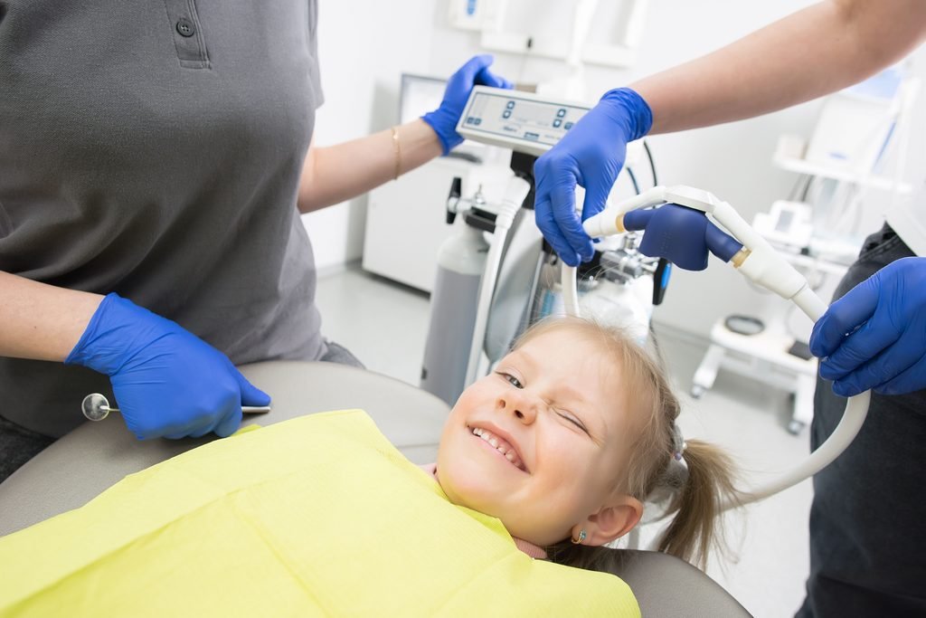 A happy child during a dental session at Smiles by Design Dental Spa 